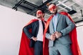 low angle view of handsome super businessmen in red masks and capes Royalty Free Stock Photo