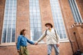 Low angle view of happy senior couple in love holding hands outdoors in town Royalty Free Stock Photo