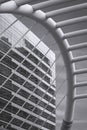 high-rise glass building inside of curve railing structure frame of Chong Nonsi skywalk bridge at Bangkok, Thailand