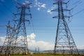 Low angle view of high voltage powerlines on the field