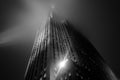 Low Angle View of a Historic Skyscraper in New York Manhattan in Black and White. Illuminated Building on a Foggy Night