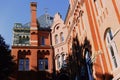 Low-angle view of historical buildings with arch-shaped window frames and ornated roofs