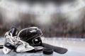 Ice Hockey Helmet, Skates, Stick and Puck in Rink