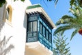 Low-angle view of a hotel window balcony in Andalusian style.