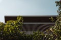 A low angle shot of a house balcony near green shrubs Royalty Free Stock Photo