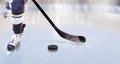 Close up of ice hockey player with stick on ice rink controlling puck Royalty Free Stock Photo