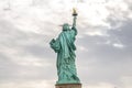 Low Angle View of Lady Liberty Statue Enlightening the World in Manhattan. Cloudy Sky in Background. Royalty Free Stock Photo