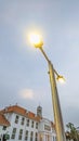 Low angle view of LED street lamp post near Dutch colonial buildings Royalty Free Stock Photo