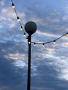 Low angle view of lights with cloudy sky in the background Royalty Free Stock Photo