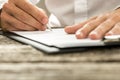 Low angle view of male hand signing contract or subscription for