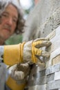 Low angle view of male worker pressing an ornamental tile into a