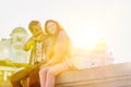 Low angle view of man holding map while sitting and talking to his girlfriend Royalty Free Stock Photo