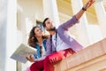 Low angle view of man holding map while sitting and talking to his girlfriend Royalty Free Stock Photo