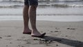 Low angle view of man legs standing on sea shore