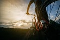 Man stand with bicycle at country road in sunset Royalty Free Stock Photo
