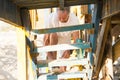 Low angle view of man tying shoelace while standing on steps Royalty Free Stock Photo