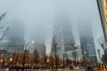 Low Angle View of Manhattan Freedom Tower and other Skyscrapers on a Foggy Night in New York. Buildings Fading into the Fog Royalty Free Stock Photo