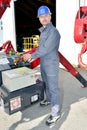 Low angle view manual worker operating crane Royalty Free Stock Photo