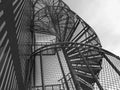 Low angle view of metallic spiral staircase against sky Royalty Free Stock Photo