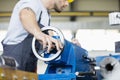 Low angle view of mid adult worker operating machinery in metal industry