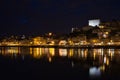 Low-angle view of modern buildings near the water at night in Oporto, Portugal Royalty Free Stock Photo