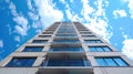 Low angle view of a modern skyscraper against a blue sky Royalty Free Stock Photo