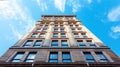 Low angle view of a modern skyscraper against a blue sky Royalty Free Stock Photo