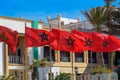 Low angle view of moroccan flags and a clock tower