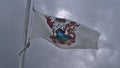 Low angle view of the municipal flag of Port Hardy, Vancouver Island with Latin text 