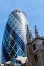 Low angle view of office buildings in the City of London against blue sky. Gherkin Royalty Free Stock Photo