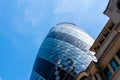 Low angle view of office buildings in the City of London against blue sky. Gherkin Royalty Free Stock Photo