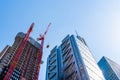 Low angle view of office buildings under construction in the City of London against blue sky Royalty Free Stock Photo