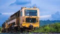 The old orange diesel locomotive on railway against blue sky in natural background