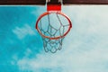 Low-angle view of an outdoor basketball hoop with a chain net Royalty Free Stock Photo