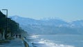 Pebble beach, surf. City embankment illuminated by lanterns. Kobuleti, Adjara, Georgia. Royalty Free Stock Photo