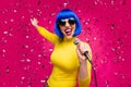 Low angle view photo of nice lady singer night club party hold microphone karaoke sound confetti fall wear specs yellow