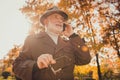 Low angle view photo of retired funny white hair grandpa walk desert park stick speaking telephone daughter son family Royalty Free Stock Photo