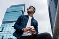 Young man wearing blue denim jacket while daydreaming outdoors i Royalty Free Stock Photo