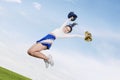 Pretty cheerleader girl jumping with pom poms Royalty Free Stock Photo