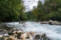 Low Angle View of Rapids on the Koritnica River with Suspension Bridge in the Background Royalty Free Stock Photo