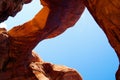 Low angle view on red sandstone bridge against blue sky - Double Arch, Arches National Park, Utah Royalty Free Stock Photo