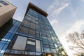 Low angle view of reflection of blue sky in glass wall of modern Royalty Free Stock Photo