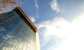 Low angle view of reflection of blue sky in glass wall of modern Royalty Free Stock Photo