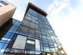 Low angle view of reflection of blue sky in glass wall of modern Royalty Free Stock Photo