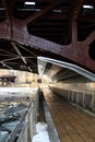 Low-angle view of a riverwalk alongside frozen Chicago River in January Royalty Free Stock Photo