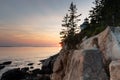 Low angle view of rocky cliff and lighthouse at sunset, Bass Harbor Royalty Free Stock Photo