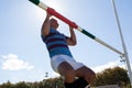 Low angle view of rugby player exercising on goal post against sky