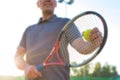 Low angle view of senior man playing tennis against clear sky on sunny day Royalty Free Stock Photo