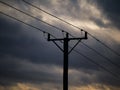 Low angle view of silhouette electricity pylon against cloudy sky Royalty Free Stock Photo