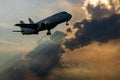 Low-angle view of a silhouette of a large passenger plane moving through a cloud